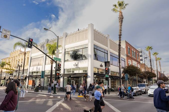 A weekday-morning sidewalk view on Union Street in Old Pasadena, showing storefronts and people walking.