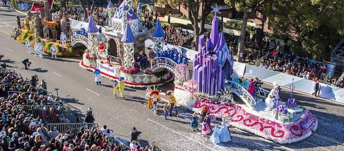 Rose Parade floats traveling along Colorado Boulevard in Pasadena, with spectators lining the curb