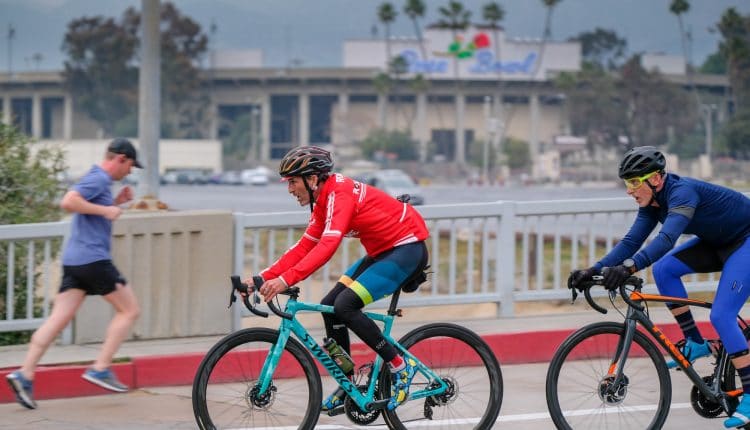 Runners and cyclists on the Rose Bowl loop, with the San Gabriel Mountains in the background